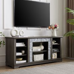 a flat screen tv mounted to the side of a wooden entertainment center in a living room