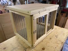 a wooden dog crate sitting on top of a table