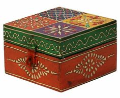 an ornately painted wooden box with decorative designs on the lid and sides, sitting against a white background