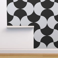 a black and white wallpaper with circles on it in an otherwise empty room next to a door