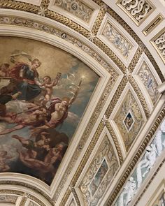 an ornate painting on the ceiling of a building