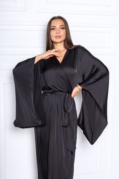 "This black silk satin robe is a kimono style robe with long wide sleeves. The robe is made of silk satin (Polyester -70%, viscosa-30%). The size of the robe on the photo is M (length is 142 cm / 56\"\"). The size and color can be chosen in the variations. What would you prefer elegance or comfort? It's probably hard to choose as even at home you want to look great and can relax after the busy day! That is why it's important to choose the right clothes. No matter if you are relaxing at home alon Bridal Kimono Robe, Long Silk Robe, Black Silk Robe, Black Satin Robe, Long Bridal Robe, Silk Bridal Robe, Long Silk Kimono, Silk Bridesmaid Robes, Silk Robe Long