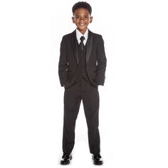 a young boy in a suit and tie posing for the camera with his hands on his hips