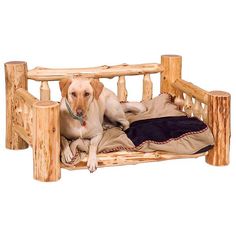 a dog laying on top of a bed made out of wooden posts and logs,