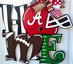 a door hanger with the word football on it and a red apple in the center