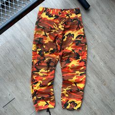 VINTAGE ' Military Orange Camo Cargo Pants sz M-Reg W33 L32 CONDITION : Wear and fading from age. No major flaws. Overall great condition/ wear ! These pants have been washed* - Please review pictures* TAGGED SIZE : ** Adult Mens M - REG* ( Fits : Mens W31-34 L32 *adjustable waist straps ) MEASUREMENTS : *Please see photos above for measurements. *Disclaimer: All measurements are in inches and are taken laying flat on the ground* * Waist measurement taken hip to hip * Length measurement taken fr Vintage Straight Leg Cargo Jeans With Side Pockets, Retro Fall Pants With Cargo Pockets, Retro Cargo Pants For Fall, Retro Cotton Cargo Pants For Fall, Retro High Waist Pants For Streetwear, Retro Straight Leg Pants With Pockets, 90s Cargo Style Bottoms For Fall, 90s Style Bottoms With Pockets For Fall, 90s Style Cargo Pocket Bottoms For Fall