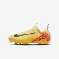 the nike vapor soccer shoe is shown in yellow and black with pink accents on the upper part