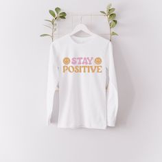 "Stay Positive Long Sleeve, Positive Vibes Tshirt, Good Vibes Tee, Motivational Shirt, Happy Tshirt, No Bad Vibes, Positivity Shirt, Think Positive Tee, Kindness Shirt I'm proud to offer FREE SHIPPING on all orders in the U.S. HOW TO ORDER ✨ Please review all listing photos for colors and sizes ✨ Choose your shirt color and size ✨ Click add to cart. You can go back to add more product ✨ Click \"Proceed to check out\" ✨ When you check out, you may also send me a message through \"Contact Seller\" White Long Sleeve Slogan T-shirt, White Long Sleeve T-shirt With Slogan, Long Sleeve T-shirt With Funny Print, Relaxed Fit, Long Sleeve T-shirt With Funny Print In Relaxed Fit, Relaxed Fit Long Sleeve T-shirt With Funny Print, White Long Sleeve Slogan Shirt, White Long Sleeve Shirt With Slogan, Motivation Tshirt, No Bad Vibes