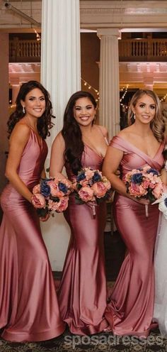 the bride and her bridesmaids pose for a photo in their pink gowns