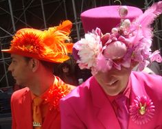 two people wearing bright colored hats and pink suits