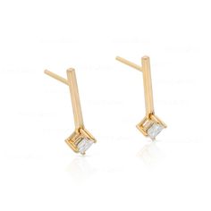 These sleek, modern bar earrings feature two princess-cut diamonds set in lustrous 10k gold. Perfect for the fashion-conscious, contemporary woman, they will be an eye-catching addition to any outfit. Modern Linear Earrings For Anniversary, Modern Formal Earrings With Single Diamond, Modern Single Diamond Earrings For Formal Occasions, Modern Diamond Linear Earrings, Modern 14k Gold Earrings With Baguette Diamonds, Modern Baguette Diamond Earrings For Gift, Modern Baguette Diamond Earrings As Gift, Modern Earrings With Baguette Diamonds As Gift, Modern Gold Baguette Cut Diamond Earrings