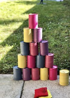 several rolls of colored paper are stacked on top of each other in front of the grass