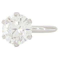 an oval cut diamond ring on a white background