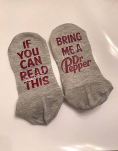 two socks that say, if you can read this bring me a soda popper