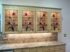 the cabinets are decorated with glass flowers