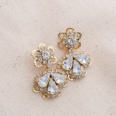 Our LEXI earrings, which are the tiny version of LEXES, are absolutely gorgeous to wear for a special occasion or a day outing. The silhouette consists of a floral design filled with crystals shaped in a leaf form to add a fine look. Handcrafted Highest Quality Swarovski / Cubic Zirconia Platinum plated Guards against scratches and tarnish. approximate size 1" length 0.5" width Nickel free Free Shipping in USA Glamorous Crystal Flower Earrings For Wedding, Dazzling Cubic Zirconia Flower Shaped Earrings, Elegant Crystal Earrings In Flower Shape, Sparkling Cubic Zirconia Flower Earrings, Elegant Crystal Flower-shaped Earrings, Glamorous Drop Flower Earrings For Pierced Ears, Glamorous Flower Drop Earrings For Pierced Ears, Elegant Crystal Flower Earrings For Party, Sparkling Flower-shaped Cubic Zirconia Earrings