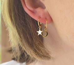 Delicate gold hoop earrings with hanging moon and star charms, perfect for wearing everyday and for stacking. Crafted from sterling silver with 0.5 micron gold plate and a high polish finish. Total drop measures 20mm, hoop measures 12mm diameter. Your purchase will arrive in a organza pouch unless gift box is selected at checkout. I will send your purchase untracked via Royal Mail, using regular post, if you prefer to have your item sent with tracking, or a more speedy posting time, please selec Jewellery Minimalist, Hoops Silver, Asymmetrical Earrings, Hoops Gold, Gold Moon, Celestial Jewelry, Moon And Star, Star Charms, Jewelry Earrings Hoops