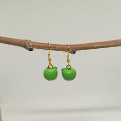 Cute and original dangle fruit earrings.   Kawaii green apple earrings  Resin apples with stainless steel hypoallergenic hooks.  Silver and golden steel hooks available A very original gift for fruit lovers, for veggies and vegans. *Measures 1.2 x 1.4cms  Total drop length: 3cms  Weight: 1.9g These earrings are carefully shipped in a cardboard box to guarantee you will receive them in perfect conditions. Please specify if you want them as a gift when you are ordering. No additional cost The pack Cute Green Jewelry With Fruit Design, Trendy Green Jewelry With Fruit Design, Trendy Green Earrings With Fruit Design, Cute Adjustable Green Earrings, Playful Green Earrings With Ear Wire, Green Dangle Earrings With Fruit Design, Cute Green Earrings With Ear Wire, Playful Green Drop Earrings, Gift Green Earrings With Fruit Design