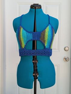 Medium handmade crochet top with lace-up back in shades of blue and green. 100% cotton. Sizing (Bust Measurement): XS = 28-30" S = 32-34" M = 36-38" L = 40-42" XL = 44-46" XXL = 48-50" For best care, hand wash or machine wash in delicates bag on a gentle cycle and lay flat to dry. Made from Sneak A Peek pattern by Kelsie at PassioKnit Goods, passioknitgoods.com. Turquoise Cotton Beach Tops, Green Cotton Crochet Top With Crochet Trim, Green Fitted Crochet Top For Beach, Fitted Green Crochet Trim Top, Fitted Cotton Crochet Top For Festivals, Green Fitted Crochet Top, Green Cotton Crochet Top For Vacation, Green Cotton Crochet Top, Blue Sleeveless Top With Crochet Trim