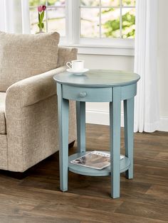 a coffee table with a magazine on it in front of a chair and a couch