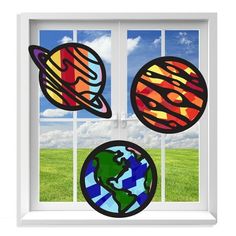 the window is decorated with three different planets