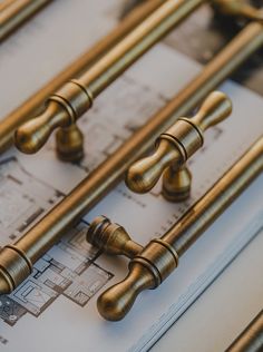 several brass handles on top of some blueprints