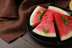 slices of watermelon on a black plate