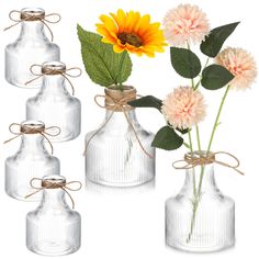 three clear glass vases with flowers in them