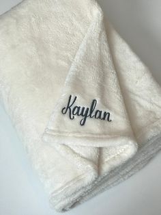 two white towels with the name kaylan embroidered on them