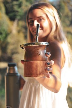 a woman holding a coffee cup in her hand