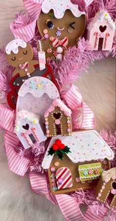 some gingerbread houses are decorated with pink ribbons