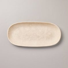 an empty white plate on a gray background