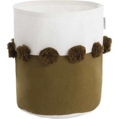 a brown and white hat with pom - poms on it