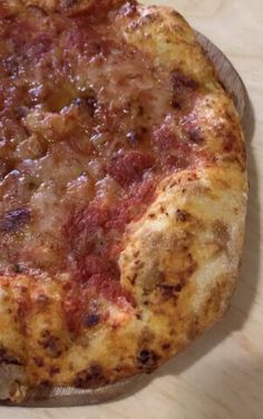 a pizza sitting on top of a wooden cutting board