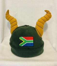 This fabulous South African springbok beanie makes a wonderful addition to your supporters kit. You know you need one in your life! All beanies are hand made from a top quality fleece with plenty of stretch to ensure a perfect fit. With the addition of an embroidered South African flag and of course the iconic springbok horns. There are four sizes available. Small - baby 6-18m Medium- 2-12 years  Medium long - teens and adult female  Large - adult male. African Hat, South African Rugby, South African Flag, Rugby Gifts, African Hats, Small Baby, Costume Hats, Medium Long, Daughter Love