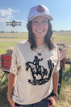 Unleash your wild side with our High Horse Tee! This Western-chic top exudes confidence and daring, perfect for those who crave adventure. Let out a yeehaw and ride into the sunset with style. Black embroidered design Studs on sleeves. Cream-colored tee. 100% Polyester. The sizing chart is located in the pictures. Graphic Tee Tops For Ranch, Western Crew Neck Tops For Rodeo, Western Tops With Graphic Print For Summer, Western Style Graphic Print Tops For Summer, Western Style Graphic Print Summer Top, Summer Graphic Tee For Rodeo, Fitted Crew Neck Top For Rodeo, Western Style Short Sleeve Tops For Rodeo, Casual Distressed Tops For Rodeo