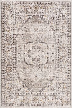 an area rug with a medallion design on the front and side, in neutral tones