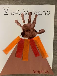 a paper plate with a handprint on it and the words vi is for volcano