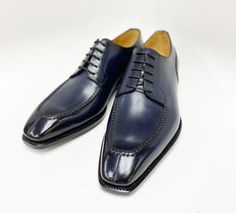 Elegant Navy Business Dress Shoes, Elegant Navy Dress Shoes For Business, Elegant Navy Oxfords For Business, Navy Elegant Oxfords For Business, Navy Plain Toe Oxfords For Formal Occasions, Classic Navy Oxfords For Business, Navy Oxfords With Brogue Detailing For Business, Elegant Navy Oxfords For Formal Occasions, Elegant Navy Dress Shoes With Leather Sole