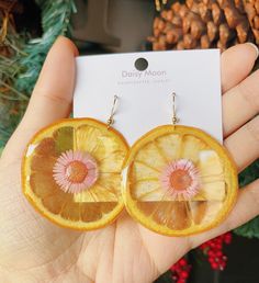 Made with real fruit and high quality resin.  Size: 2.4 inch The earrings post/hoop is made of 18k gold plated Sterling silver for sensitive earrings. Lead free The colors for each piece will be slightly different as they are made of real flowers or fruits. Cute Resin Earrings At Affordable Price, Yellow Fruit Design Earrings For Gift, Yellow Fruit Design Earrings As Gift, Yellow Fruit Design Earrings Gift, Gold Earrings With Fruit Design For Gift, Orange Fruit Design Earrings As Gift, Yellow Flower Hoop Earrings For Gift, Yellow Flower-shaped Hoop Earrings Gift, Yellow Flower Shaped Hoop Earrings As Gift