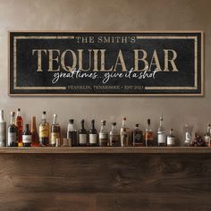 a bar with liquor bottles on it and a sign that reads tequila bar great times give at a shot