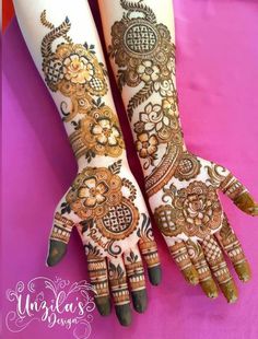 two hands with henna tattoos on them, one is showing the intricate design and the other has flowers