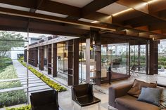 a living room filled with furniture and lots of windows