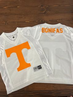 Football season is here! Celebrate the Vols with this jersey for your little one!  Each jersey can have a name & number on the back. A heat pressed is used to make all of our clothing to ensure the design does not peel up! **All Jersey's will have the last name placed on the back please leave this during checkout in the note section. If no number is listed only the last name will be printed on the jersey.  Care Instructions: Wash inside out with mild detergent hang dry to prolong the life of the White Team Spirit Jersey For College, White Jersey For College With Team Spirit Style, White College Jersey With Letter Print, College White Jersey With Letter Print, College Team Name White Jersey, White College Jersey With Team Logo, College White Jersey With Team Logo, White Letter Print Jersey For Game Day, Game Day White Baseball Jersey With Team Name