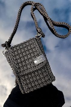 Crochet crossbody polyester cord bag, hand knitted cell phone pouch, crochet mini purse mobile phone case, black shoulder messenger bag. Embrace the artistry of handmade accessories with our exquisite Crochet Crossbody Bag--a versatile piece that effortlessly combines fashion and function. This thoughtfully designed bag serves as a cell phone pouch, crochet mini purse, and mobile phone case, making it the perfect summer shoulder messenger bag for those on the go. Key Features: ● Chic and Practic Diy Roommate Gifts, Phone Pouch Crochet, Crochet Mini Purse, Cotton Crochet Patterns, Pochette Portable, Crochet Mini Bag, Crochet Crossbody Bag, Mini Sling Bag, Cell Phone Pouch