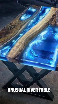 a table that has been made to look like an abstract piece of wood with blue paint on it