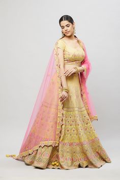 Beautifully embroidered with gold aari and pink resham embroidery, this lehenga will brighten up any wedding event! Fabric: Raw silk blouse and lehenga, Net dupatta All preorders will be handled by a Nazranaa Bridal Consultant who will virtually discuss measurements and minor changes according to the client's specifications Occasion: Wedding Events such as sangeet or wedding ceremony WASH CARE INSTRUCTIONS - Please Dry clean only when it is applicable. Slight color variation is possible due to d Yellow Lehenga With Resham Embroidery, Yellow Lehenga With Resham Embroidery In Chinon, Yellow Embroidered Dola Silk Lehenga, Yellow And Orange Lehenga, Pink Yellow Lehenga, Raw Silk Blouse, Resham Embroidery, Bridal Consultant, Net Dupatta