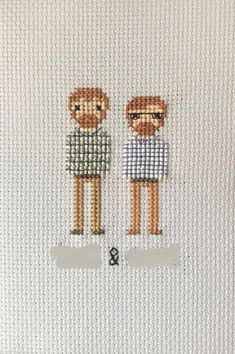 two cross stitch people standing next to each other