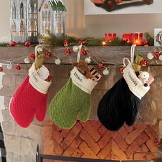 stockings hanging from a mantel decorated with christmas decorations