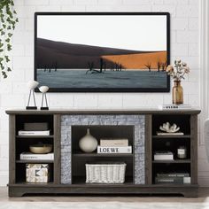 a living room with an entertainment center and large painting on the wall